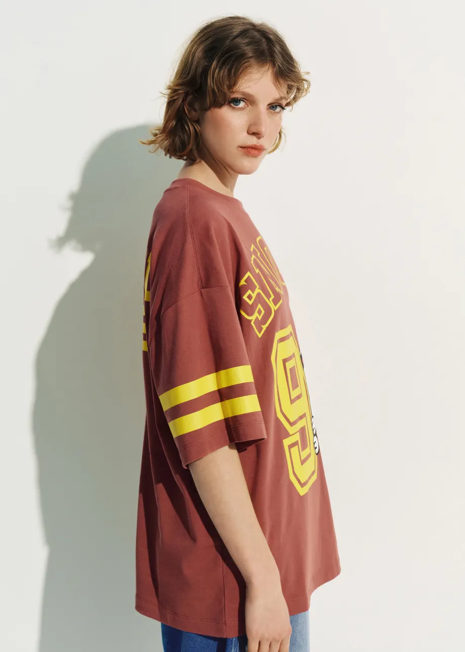 Brown T-shirt with Peanuts™ Snoopy print and yellow text