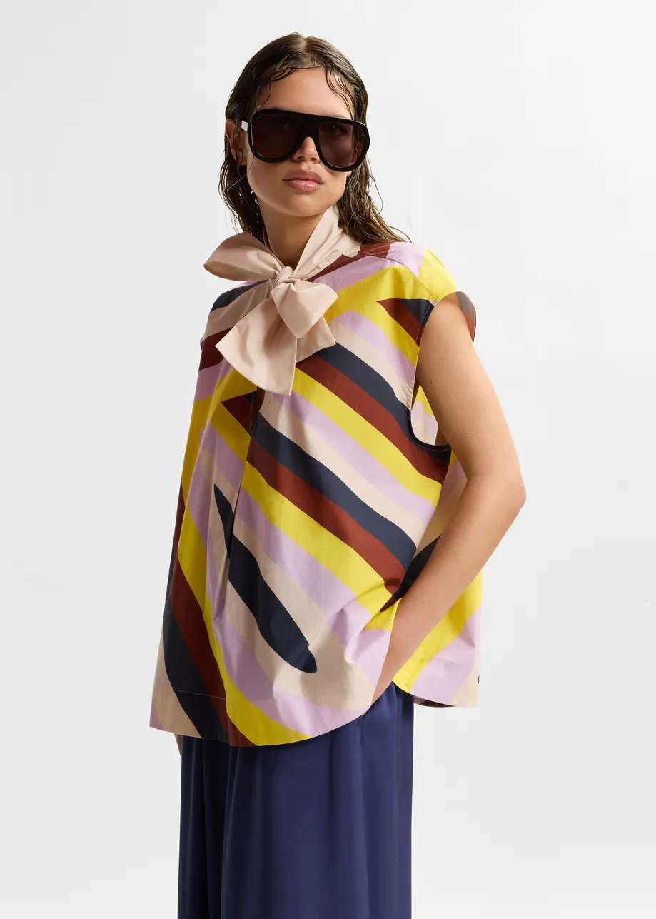 Cream and multicolor graphic sleeveless top with tie neckline
