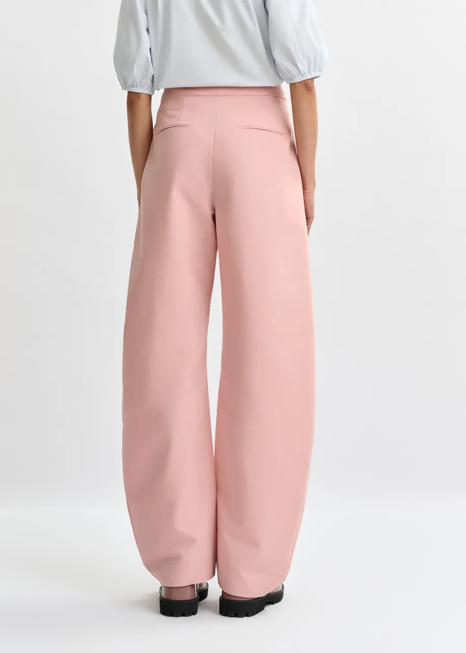 Light pink barrel-leg pants with pleated waist