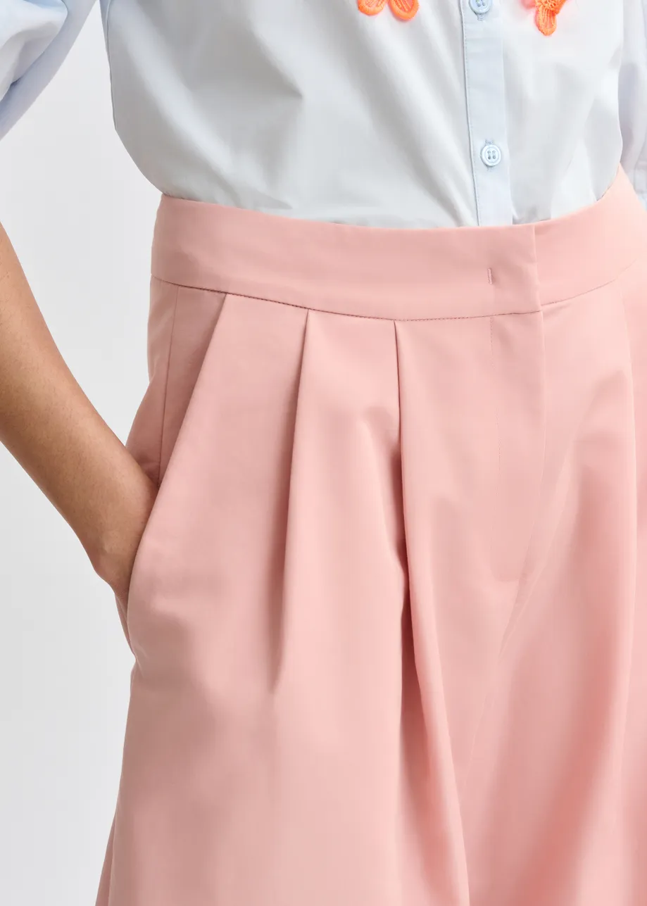 Light pink barrel-leg pants with pleated waist