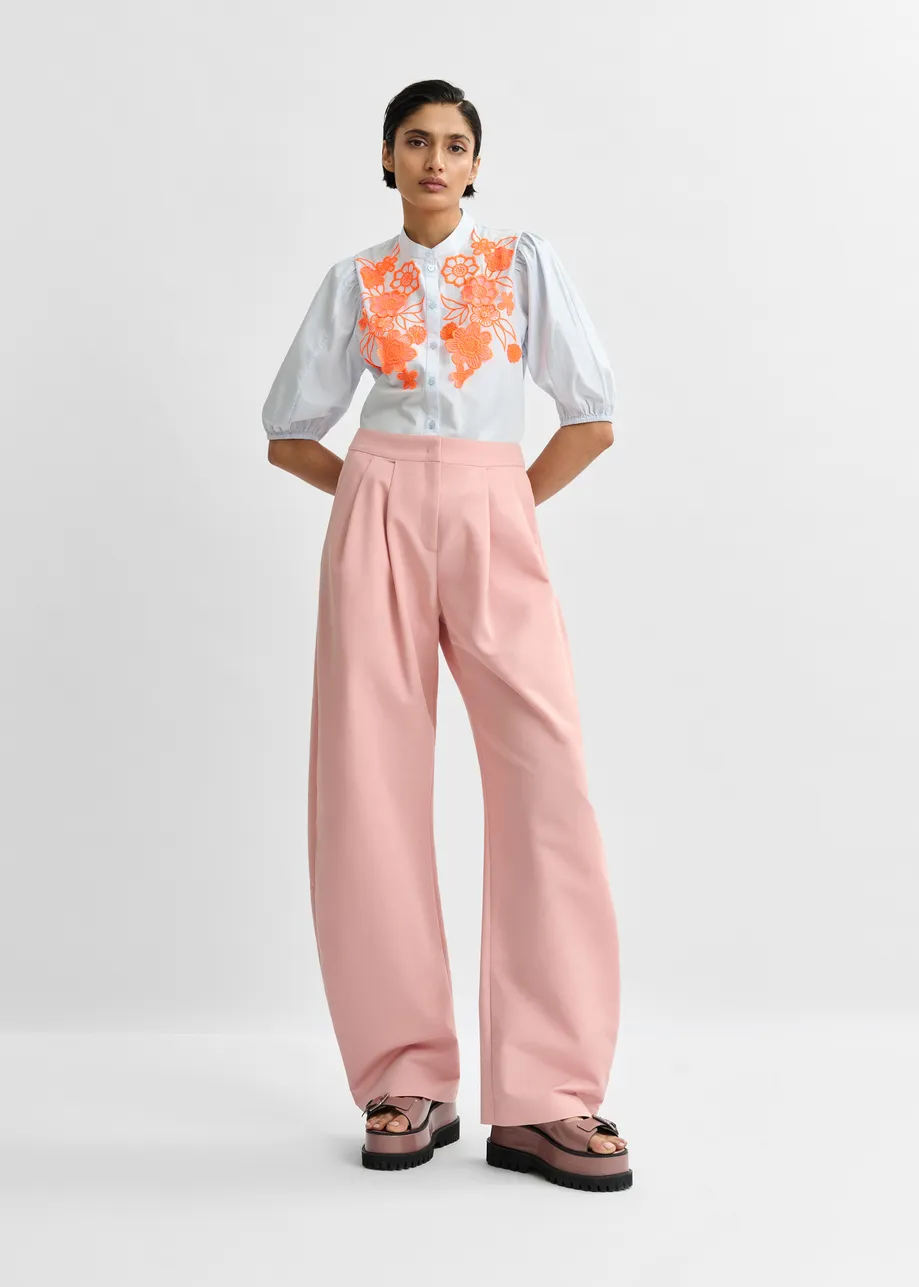 Light pink barrel-leg pants with pleated waist