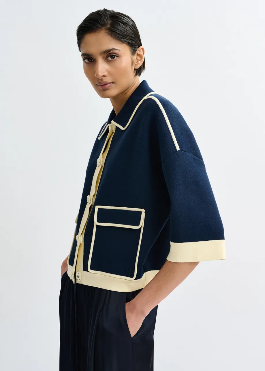 Marineblauwe cardigan met bloemetjesknopen en gebroken witte contrastboord