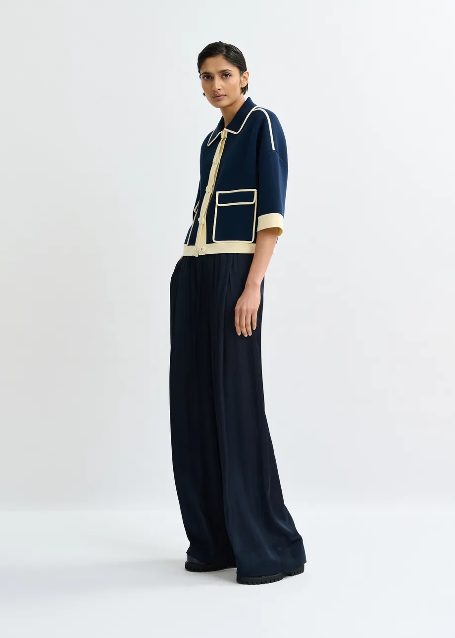 Navy knit cardigan with flower buttons and off-white contrasting trims