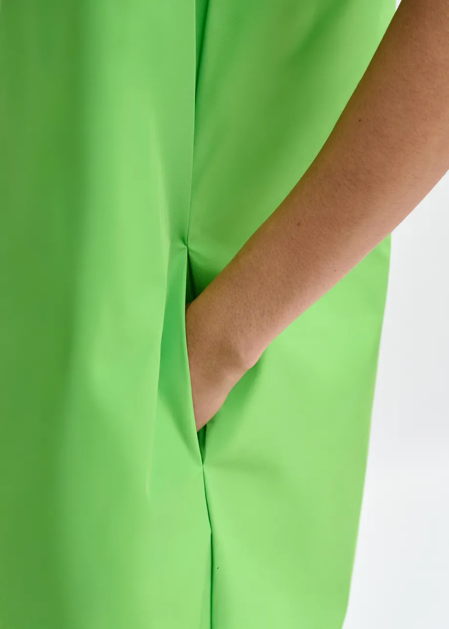 Green one-shoulder mini dress with ruffle details
