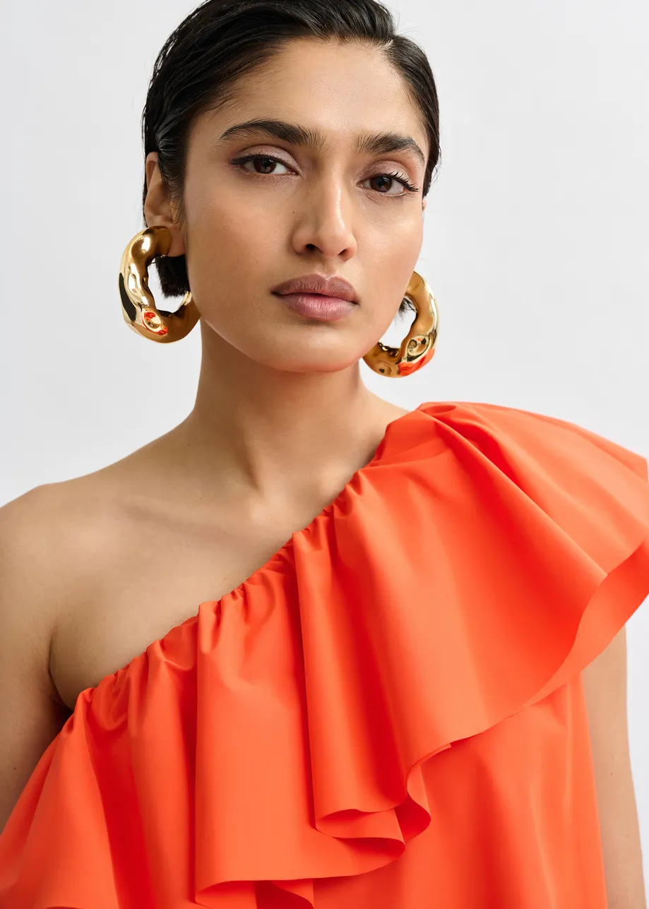 Orange one-shoulder mini dress with ruffle details