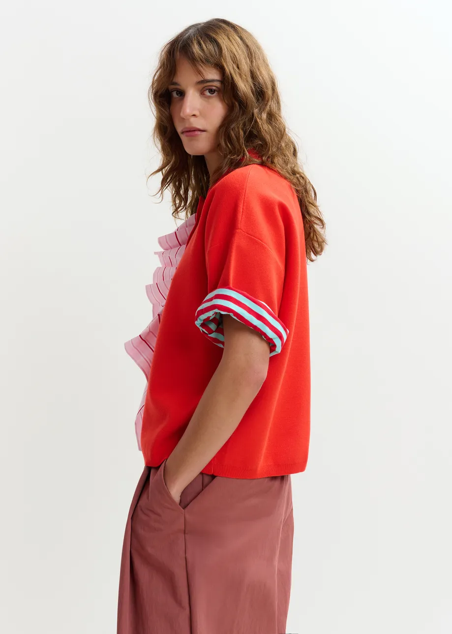 Oranje en lichtroze fijngebreide polo met volants