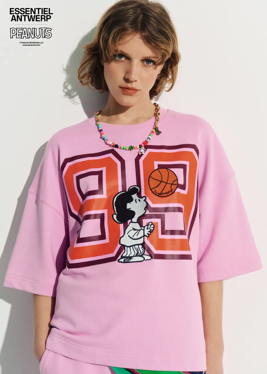 Pink T-shirt with appliquéd Peanuts™ Lucy patch and text print