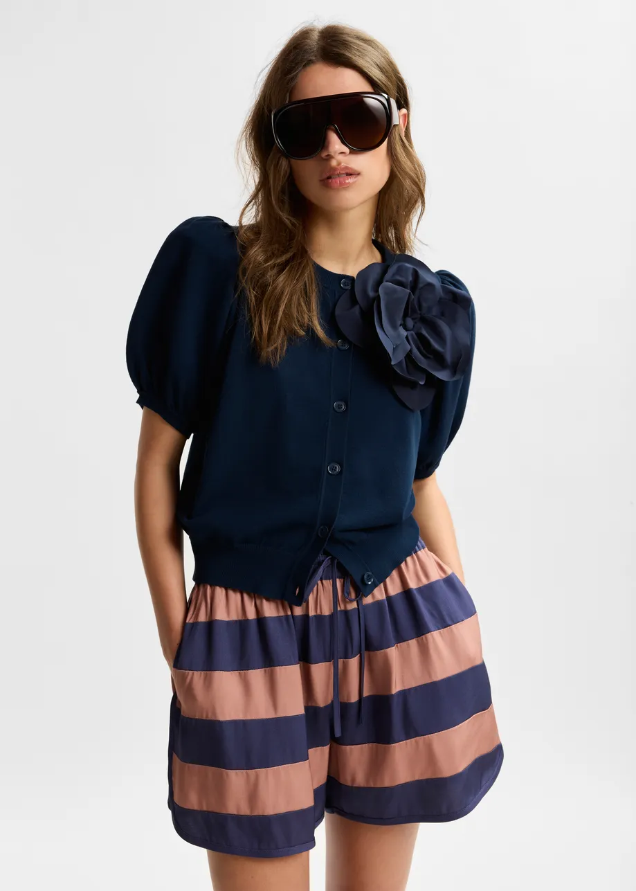 Dark blue fine knit cardigan with oversized flower brooch