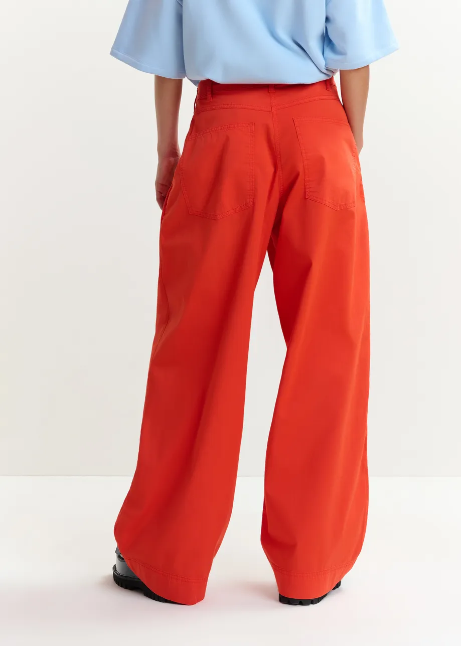 Orange pleated wide-leg pants