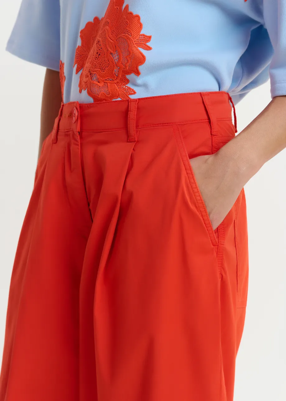 Orange pleated wide-leg pants