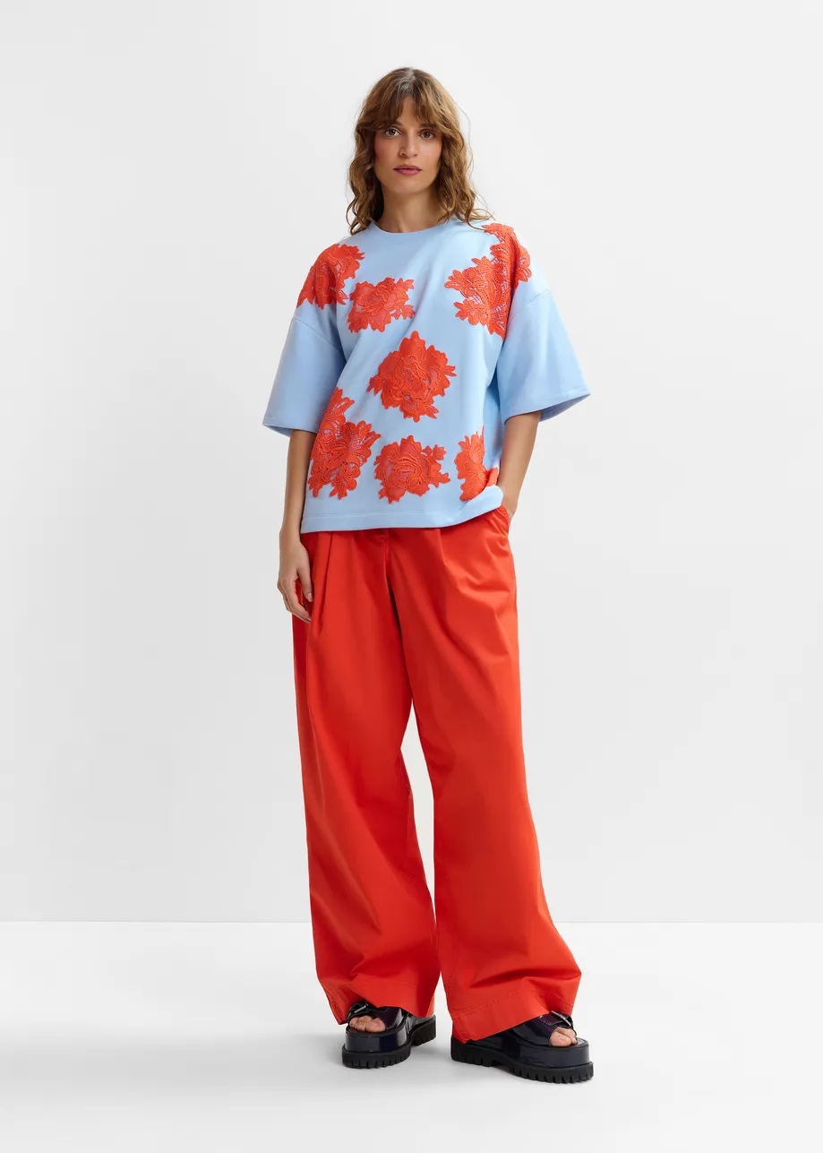 Orange pleated wide-leg pants