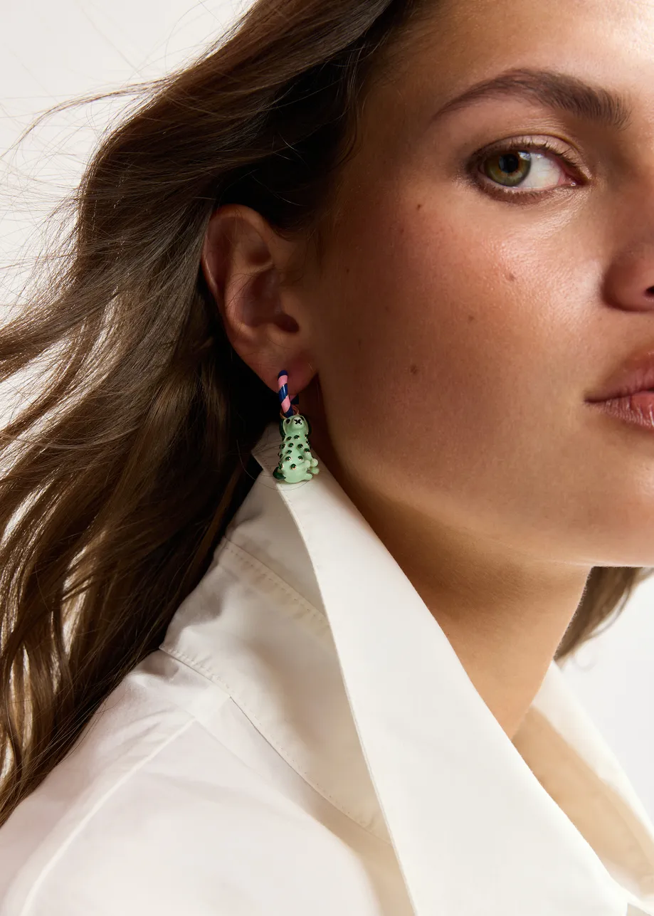 Pink and blue hoop earrings with dog and orange pendants