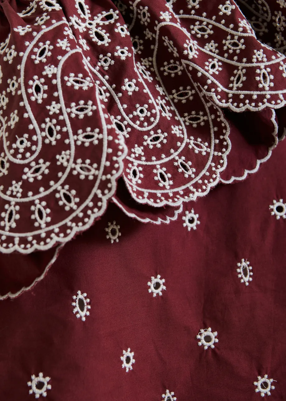 Dark red and white embroidered one-shoulder cotton top with ruffle detailing 