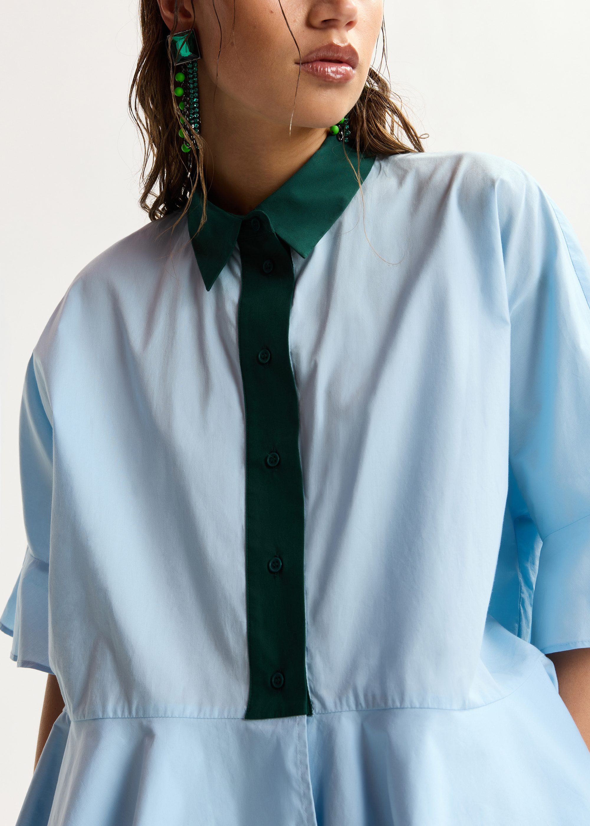 Light blue cotton peplum shirt with dark green contrast detailing