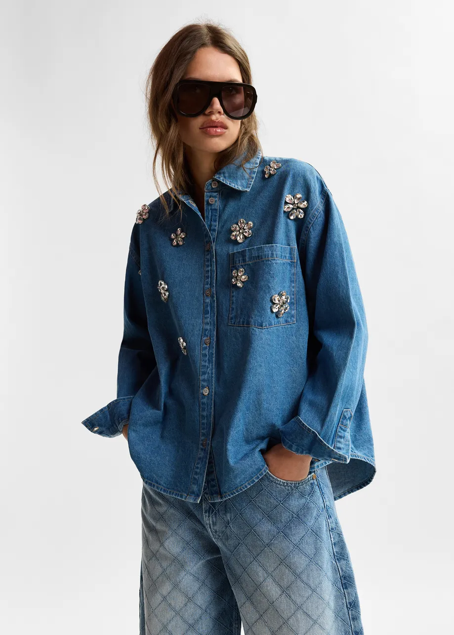 Blue denim shirt with floral rhinestone embellishments