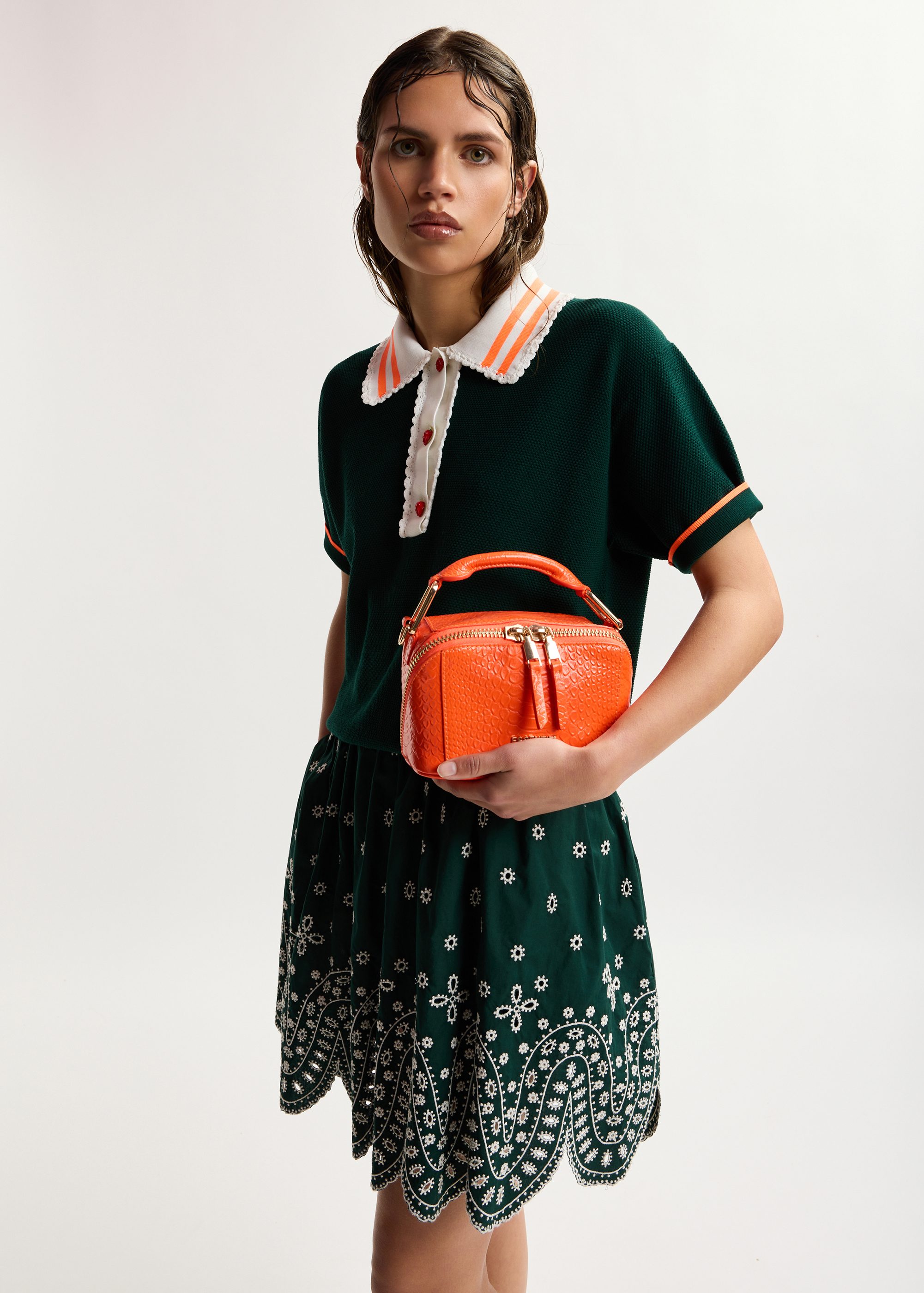 Dark green fine knit polo top with white and orange lace-trimmed