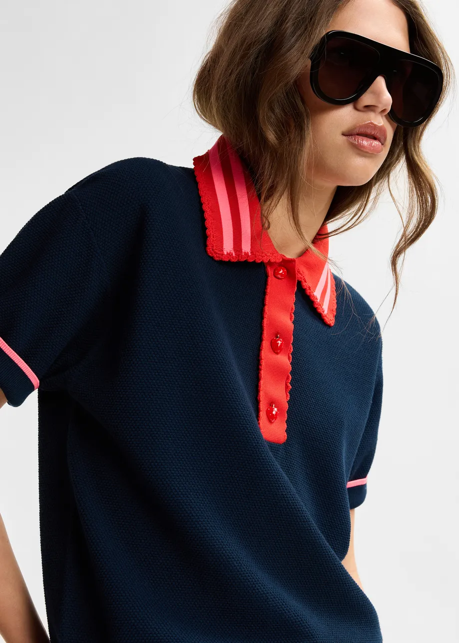 Navy fine knit polo top with red and pink lace-trimmed collar and strawberry-shaped buttons