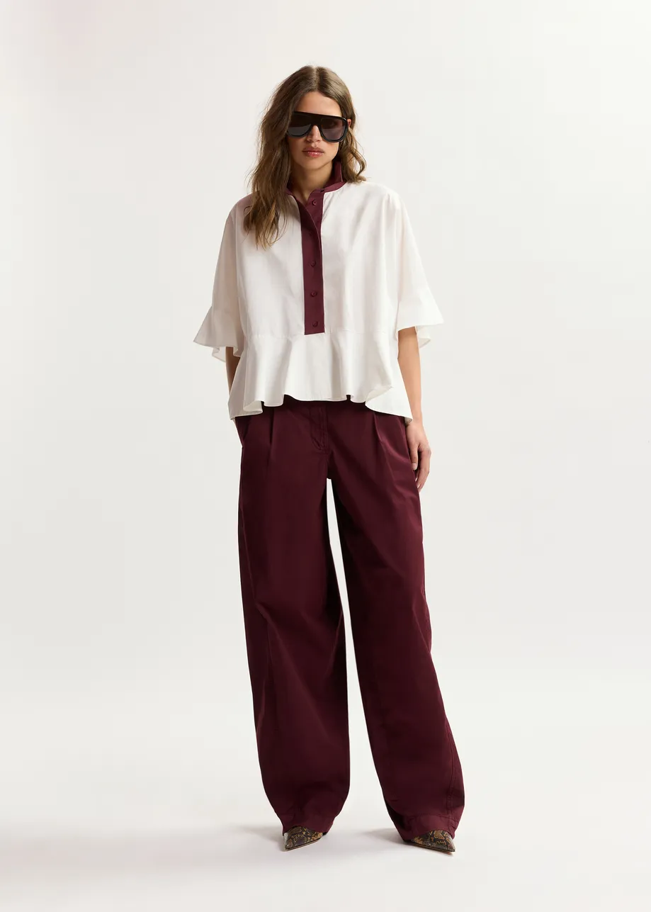 Dark red tapered cotton pants with twisted seams